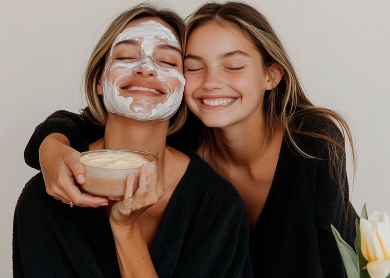 Mother and daughter enjoying a spa facial holding a bowl